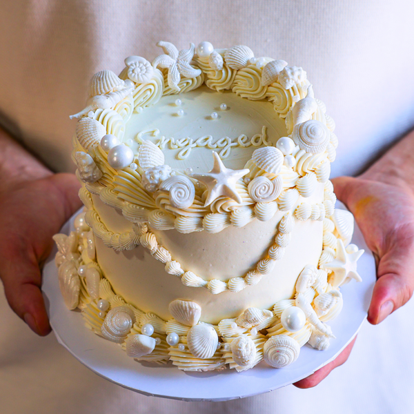 Beach inspired cake with shell decorations 