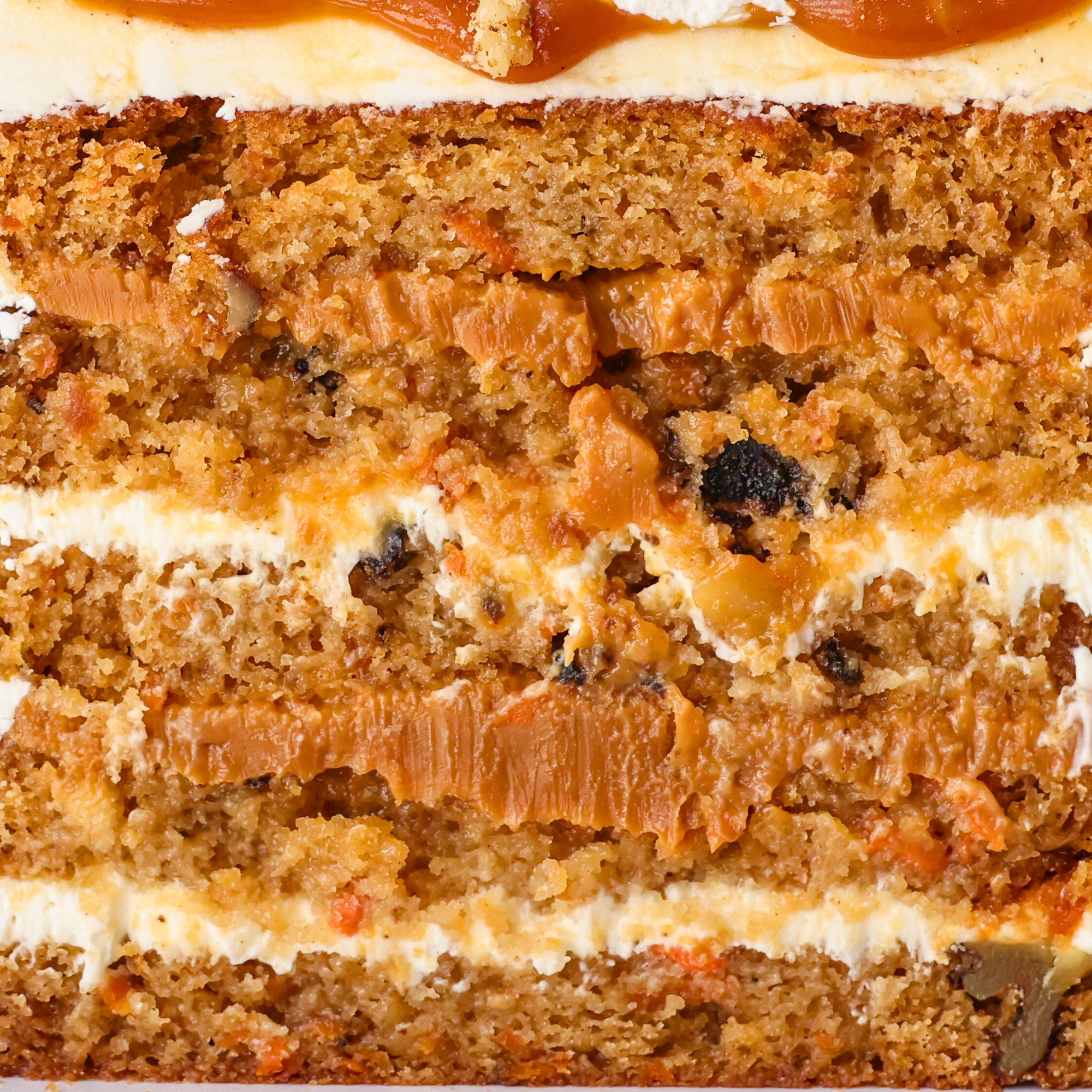 Close-up of a slice of carrot cake with cream cheese frosting