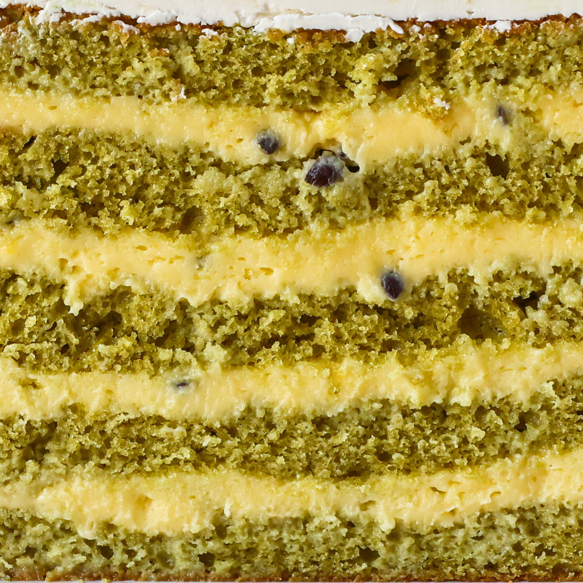 Close-up of a layered cake with green and yellow layers