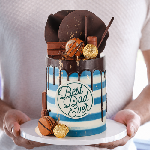 Cake with 'Best Dad Ever' text held by a person