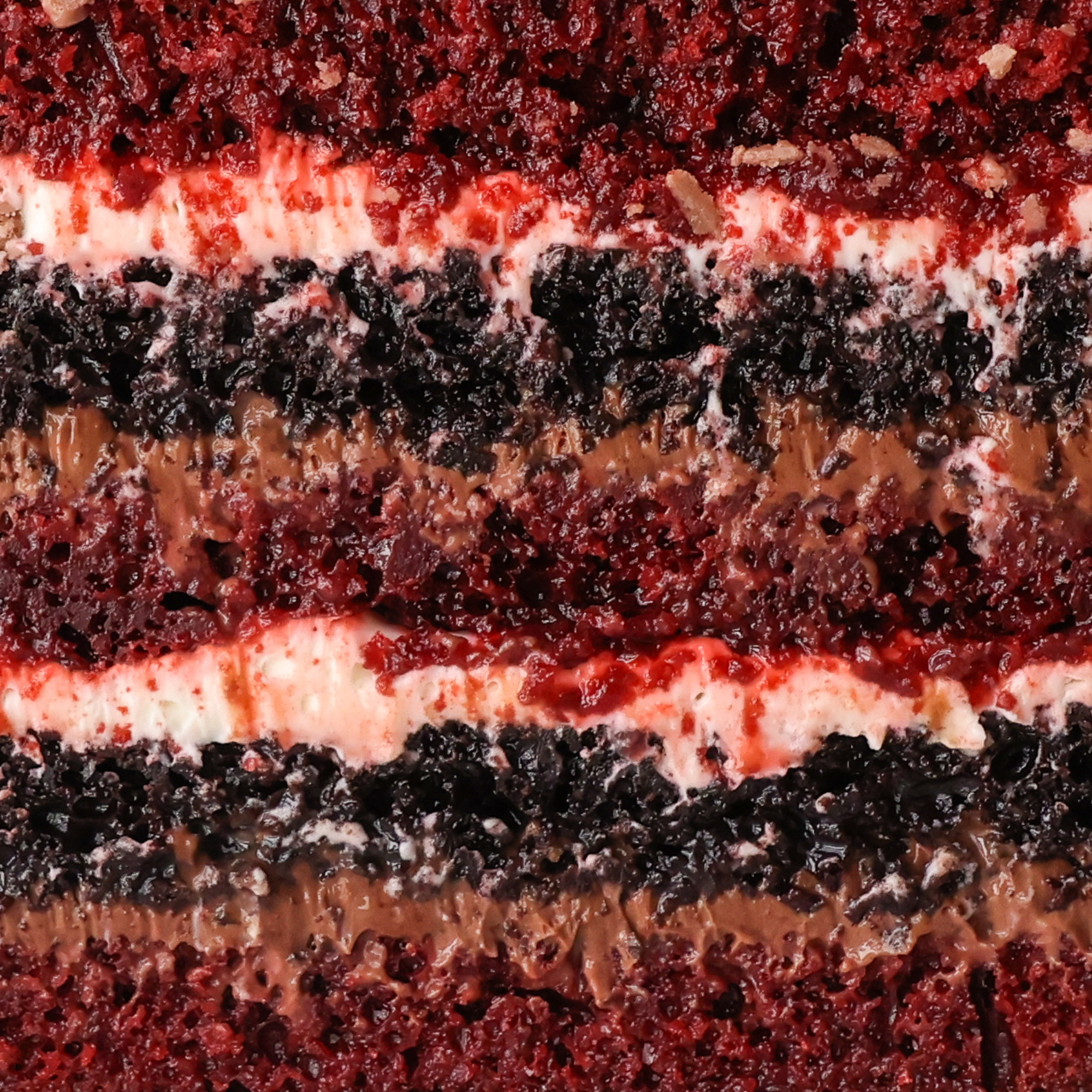 Close-up of a layered cake with red, white, and brown colors
